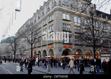 Die Zürcher Bahnhofstraße am Weihnachtseinkaufstag voll mit Personen vor dem Coop City, die Bahnhofstraße in Zürich zur X-MAS-Shopping-Zeit voller PE Stockfoto