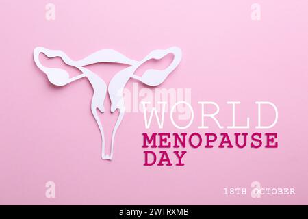 Weltmenopause Tag - 18. Oktober. Papier Uterus auf rosafarbenem Hintergrund, Draufsicht Stockfoto