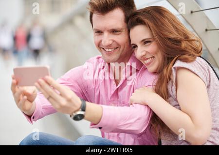 Ein Paar macht ein Selfie zusammen mit einem Telefon Stockfoto