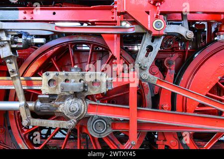 Zwei rote Räder einer alten Dampflokomotive mit Antriebsgestänge Stockfoto