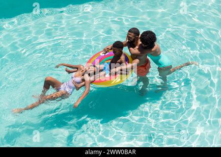 Eine afroamerikanische Familie genießt einen sonnigen Tag im Pool Stockfoto