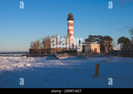 Schneebedeckter Blick auf den Shepelevsky-Leuchtturm, den Golf von Finnland, die Region Leningrad Oblast, Russland, den sonnigen Wintertag mit blauem Himmel, Leuchttürme und Leuchtfeuer von Rus Stockfoto