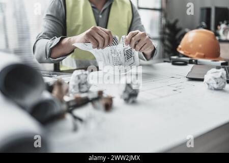 Der Architekt machte einen Fehler beim Entwurf des Plans und zerrissenes Papier. Papiercrump auf Blueprint. Fehler, Fehler und Problem Konzept. Stockfoto