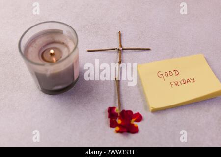 Eine Gruppe von gelben Haftnotizen auf weißem Hintergrund, die den Text „Karfreitag“ neben einer einfachen Zeichnung eines Kreuzes und einer brennenden Kerze zeigen Stockfoto