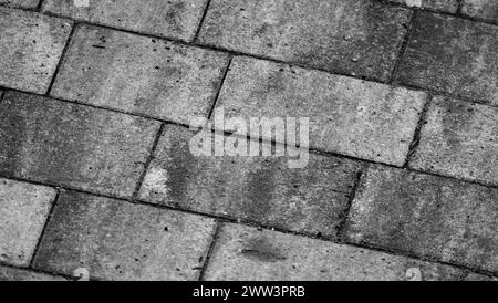 Rauer grauer Betonpflaster-Straßenhintergrund, Pflasterplatten-Muster Stockfoto