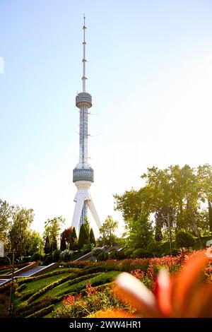 Taschkent Fernsehturm Toshkent Teleminorasi und rote Blumen im Park bei Sonnenuntergang in Usbekistan Stockfoto