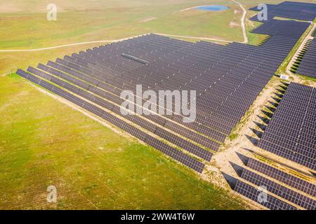 Von oben ist ein großes Feld von Solarpaneelen dargestellt. Die Felder sind in Reihen angeordnet und über das Feld verteilt. Das Konzept von Weite und Skala Stockfoto