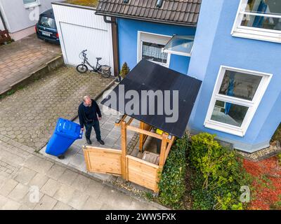 Einfamilienhaus mit verschiedenen Solarmodulen, neben Solarpanelen auf dem Hausdach, sind auf einer Mülltonnenbox Steckersolar Module als Dach montiert, Essen, NRW, Deutschland, Solarenergie *** Einfamilienhaus mit verschiedenen Solarmodulen, zusätzlich zu Solarpanelen auf dem Dach des Hauses, steckbare Solarmodule werden auf einer Mülltonne als Dach montiert, Essen, NRW, Deutschland, Solarenergie Stockfoto