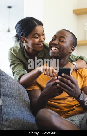 Das afroamerikanische Paar genießt einen Moment mit einem Smartphone Stockfoto