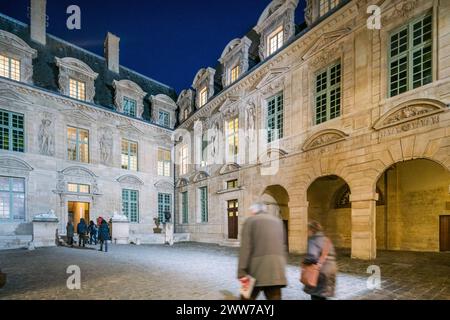Hotel de Sully, ein privates Herrenhaus im Marais, Paris, beleuchtet in der Abenddämmerung. Stockfoto