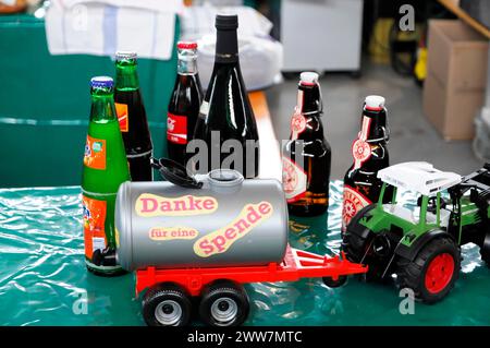 RETRO CLASSICS 2010, Stuttgarter Messe, Spendenaufruf mit Spendendose umgeben von Getränkeflaschen und einem kleinen Traktor, Stuttgarter Handel Stockfoto