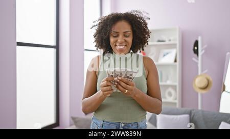 afroamerikanerin mit Geld drinnen Stockfoto