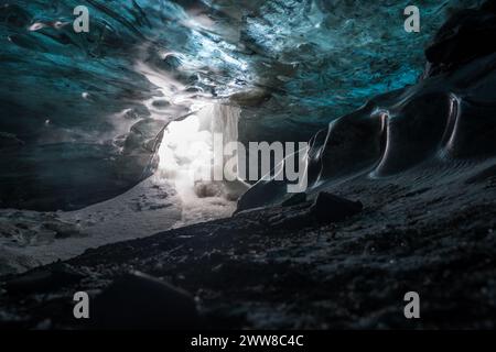 Geheime blaue und schwarze Eishöhle in Island Stockfoto