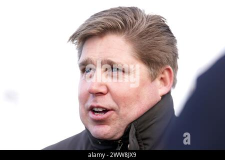 Trainer Dan Skelton, nachdem er das Pferd Doyen Quest von Jockey Harry Skelton (nicht abgebildet) gesehen hatte, gewann er die Daily Racing Specials bei BetVictor Handicap Hürdenlauf auf der Newbury Racecourse, Berkshire. Bilddatum: Freitag, 22. März 2024. Stockfoto