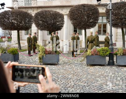 Ein Tourist fotografiert die Soldaten der 32. Budapester Garde und des zeremoniellen Regiments auf der Wache im Sandorpalast. Stockfoto