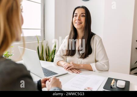 Lächelnder HR-Manager, der mit dem Kandidaten im Amt spricht Stockfoto