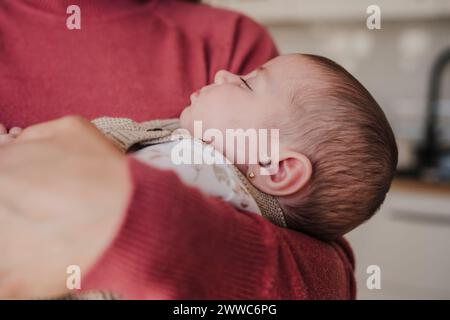 Süßes Mädchen, das im Arm der Mutter schläft Stockfoto