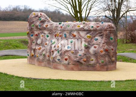 Kleine künstliche Kletterwand mit bunten Griffen im Sportpark Stockfoto