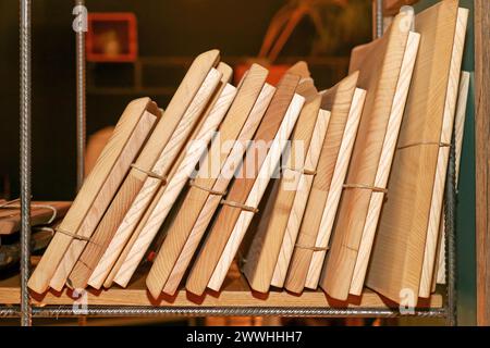 Stapel alter Bücher mit Papiereinband auf Holzregal Stockfoto