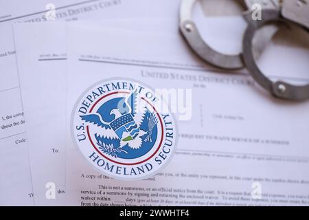 KIEW, UKRAINE - 9. MÄRZ 2024 Siegel des US Department of Homeland Security mit Handschellen auf viele Haftbefehle und Beschwerden des US District Court Nahaufnahme Stockfoto