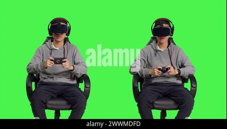 Gamer, der Spaß mit rpg-Spielen mit modernen Geräten über Greenscreen-Hintergrund hat, nimmt an Online-Gaming-Wettbewerben mit Freunden Teil. Asiatischer Mann, der sich mit dem vr-Headset entspannt fühlt. Stockfoto