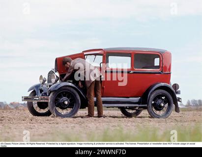 Das alte Auto. Ein Mann, der sich etwas im Motor seines Autos ansieht, einen Ford Model A 1930. Stockfoto