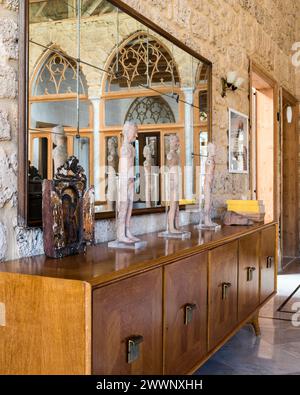 Figuren auf hölzernem Sideboard mit Spiegel in einer Luxuswohnung in Beirut, Libanon. Stockfoto