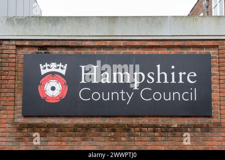 Großes Schild für den Hampshire County Council mit seinem Emblem an der Seite eines Gebäudes in Winchester, England. März 2024. Stockfoto