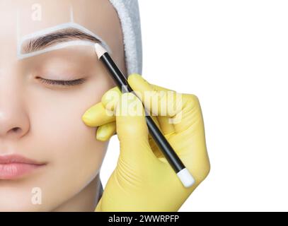 Permanent Make-up für Augenbrauen einer schönen Frau mit dicken Augenbrauen im Schönheitssalon. Nahaufnahme-Kosmetikerin, die Augenbrauen tätowiert. Stockfoto