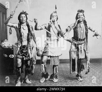 Gerhard Sisters – drei indianische Männer in traditioneller Kleidung posierten, als würden sie einen Schlangentanz aufführen – 1905 Stockfoto