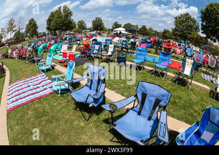 Suwanee, GA / USA - 12. August 2023: Dutzende leere Rasenstühle werden für ein Sommerkonzert im Suwanee Town Park Amphitheater aufgestellt. Stockfoto