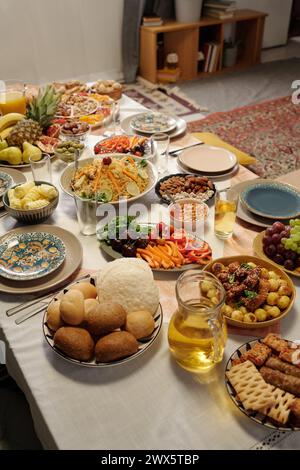 Vertikale Hochwinkelaufnahme keine Leute vom festlichen Tisch mit verschiedenen köstlichen Gerichten, die für Eid Al-Fitr-Feier zubereitet wurden Stockfoto