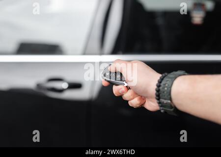 Der Mann Hält Die Schlüssel Und Öffnet Das Auto. Autovermietung Und Probefahrt Stockfoto