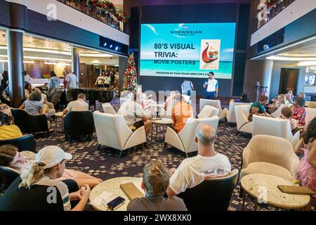 Miami Florida, PortMiami Hafen von Miami, Innenausstattung, norwegisches Schiff Joy Cruise Line, 7-tägige Karibik, das Atrium-Trivia-Spiel, Stühle sitzender Mann Stockfoto