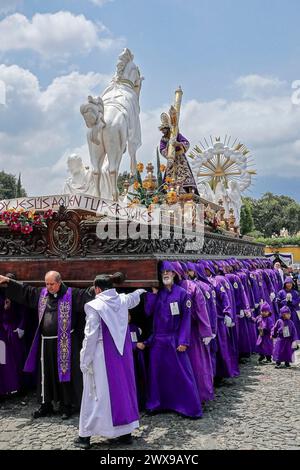 Antigua, Guatemala. März 2024. Costaleros tragen den gewaltigen Jesús Nazareno del Perdón Prozessionswagen von der San Francisco El Grande Kirche in Semana Santa, 28. März 2024 in Antigua, Guatemala. Die opulenten Prozessionen, detailgetreuen Alfombras und jahrhundertealten Traditionen ziehen mehr als 1 Million Menschen in die alte Hauptstadt. Quelle: Richard Ellis/Richard Ellis/Alamy Live News Stockfoto