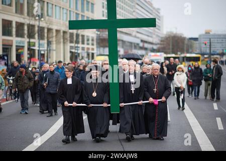 Die großen christlichen Kirchen begehen am 29.03.2024 wieder eine Karfreitagsprozession durch Berlins Mitte. Sie sollen an den Leidensweg Christi erinnern. An der Spitze des Zuges wird traditionell ein rund 50 Kilogramm schweres Kreuz getragen. Die oekumenische Prozession beginnt im Anschluss an einen Gottesdienst in der Marienkirche am Alexanderplatz. Von dort fuehrt sie zum Berliner Dom, ueber die Straße unter den Linden zur Neuen Wache und endet auf dem Bebelplatz vor der Hedwigs-Kathedrale. Im Bild vlnr.: Superintendentin Silke Radosh-hinder, Bischof Emmanuel von Christoupolis, Erzbischof Stockfoto