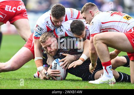 Luke Thompson von Wigan Warriors wird von Jack Welsby aus St. angegriffen Helens und Daryl Clark aus St. Helens während des Spiels der Betfred Super League Runde 6 St Helens gegen Wigan Warriors im Totally Wicked Stadium, St Helens, Vereinigtes Königreich, 29. März 2024 (Foto: Craig Thomas/News Images) in, 29. März 2024. (Foto: Craig Thomas/News Images/SIPA USA) Credit: SIPA USA/Alamy Live News Stockfoto