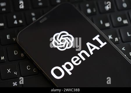 KIEW, UKRAINE - 17. MÄRZ 2024 OpenAI-Logo auf iPhone-Display und MacBook-Tastatur. Engine für künstliche Intelligenz Stockfoto