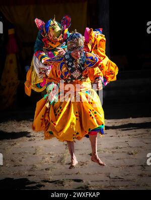 Tänzer gehen in die Luft beim Jambey Lhakhang Temple Festival in Jakar, Bhutan. Stockfoto