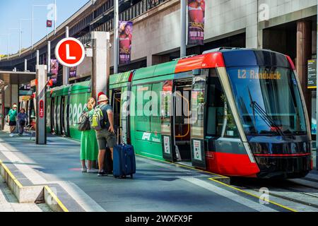 Passagiere auf dem Bahnsteig mit einer Straßenbahn, die auf die Abfahrt wartet, Circular Quay, Sydney, New South Wales, Australien, Dienstag, 12. März 2024. Stockfoto