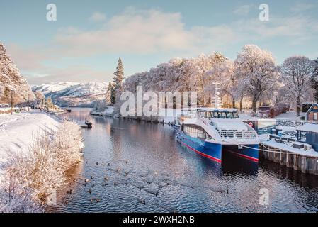 Loch Ness Kreuzfahrtschiffe auf dem Caledonian Canal in Fort Augustus mit schneebedeckter Umgebung an einem sonnigen Wintertag Stockfoto