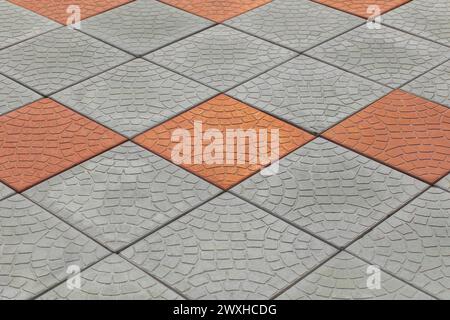 Braun Orange Pflasterplatten Steinmosaik Abstrakte Muster Oberfläche Straßenboden Straße Textur Hintergrund Fliesen Streifen Linien. Stockfoto