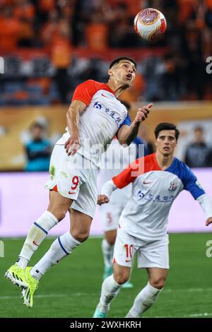 Jinan, Chinas Provinz Shandong. 31. März 2023. Andre Luis (L) von Shanghai Shenhua führt den Ball während des Spiels der chinesischen Fußballverband Super League (CSL) 2024 in der dritten Runde zwischen Shangdong Taishan und Shanghai Shenhua in Jinan, ostchinesischer Provinz Shandong, am 31. März 2023. Quelle: Zhu Zheng/Xinhua/Alamy Live News Stockfoto