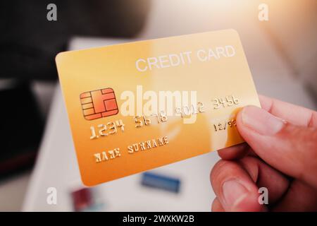 Modell der gelben Kreditkarte in Hand mit Sonnenlicht, Kredit- oder Debitkarte Finanzkonzept Stockfoto