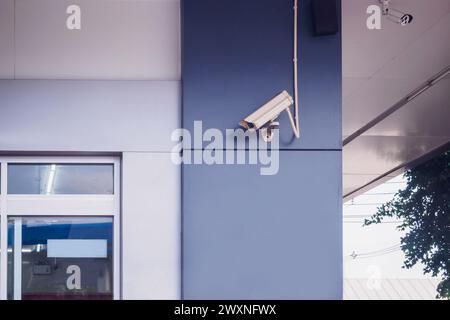 Überwachungskamera an der Wand vor dem Geschäft Stockfoto