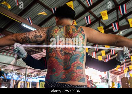 Bangkok, Thailand. April 2024. Bei einem Thai-Mann wird seine Brust von einem Militärangehörigen während eines jährlichen Militärzugs im Wat Samakchhitham gemessen. Die Royal Thai Armed Forces starteten ihre jährliche Wehrpflicht mit der Suche nach gesunden Männern ab 21 Jahren aus dem ganzen Land vom 1. April 2024 bis zum 12. April 2024, indem sie freiwillig und im Lotto eine Lotterie verzeichneten. (Foto: Peerapon Boonyakiat/SOPA Images/SIPA USA) Credit: SIPA USA/Alamy Live News Stockfoto