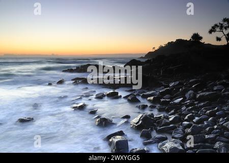 Cabarita Beach mit Norries Headland Silhouette gegen Sonnenaufgang Stockfoto