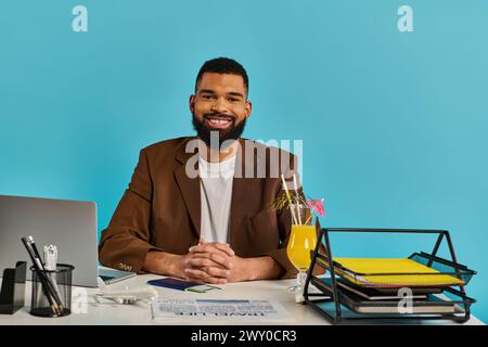 Ein Mann sitzt an einem Schreibtisch und konzentriert sich auf seinen Laptop-Bildschirm. Seine Hände tippen, während er intensiv an seinem Computer arbeitet. Stockfoto