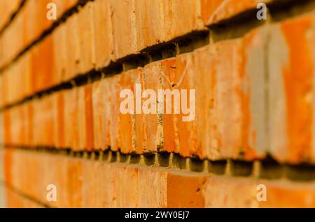 Eine abstrakte Fotografie des Grundrisses von Ziegeln, die die Außenwand eines Hauses bilden. Stockfoto