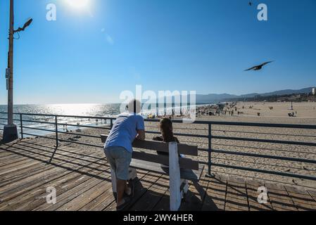 Zwei Personen, die den Blick auf Santa Monica Beach vom Pier aus betrachten - Los Angeles, Kalifornien Stockfoto